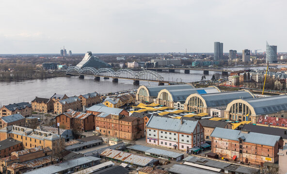 Aerial view of the historic Riga Central Market with its iconic zeppelin hangars, located along the Daugava River in Riga, Latvia.