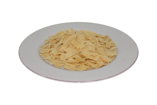 Crispy snack crackers in square shape on white plate, isolated on Transparent background