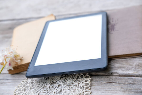 ebook reader on stack old paper books on wooden table, electronic book, digital reading device and vintage literature contrast, technology vs tradition, Back to school and education, blank copy space