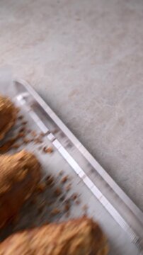 Crunchy almond croissants on baking tray with parchment put into oven and taken out after baking. Bakery video with oven process. Pastry, dessert and homemade baking concept.