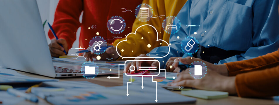 A collaborative scene featuring a diverse team working together on cloud technology solutions with a laptop, showcasing digital icons that represent data management and connectivity. Trope