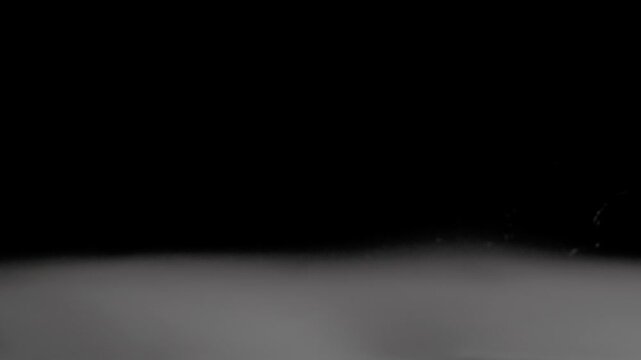 White smoke floats along the bottom of the frame and fades away slowly.