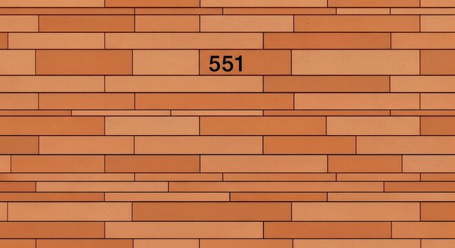 Brick wall texture displays a repeating pattern of terracotta rectangular blocks with the number five hundred fifty one centered in the middle of the surface.