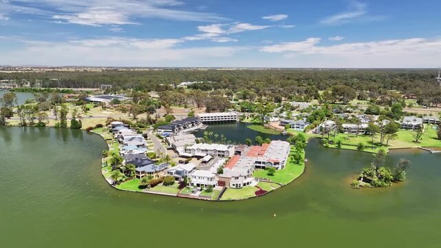 Waterfront houses and apartments occupy a curved lakeside peninsula