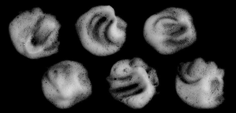 Six realistic white soap foam blobs isolated on black background, showing bubbles, wet texture and organic shapes. Cleaning, hygiene, detergent, skincare and abstract liquid effect concept.