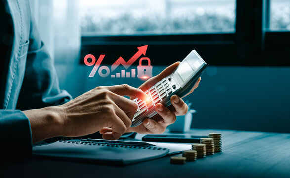Interest rate risk management concept with person using calculator beside rising percentage chart lock icon and coin stacks showing secure loan cost financial planning and business finance strategy