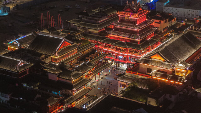Aerial view of Yu Garden at night, featuring traditional Chinese architecture with illuminated curved roofs and vibrant red lanterns in Shanghai, Shanghai, China.