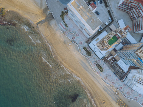 Aerial view of the sandy beach and coastal promenade in Calp, Valencian Community, Spain.