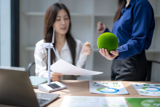 Businesswomen discussing esg sustainability incorporating green energy solutions