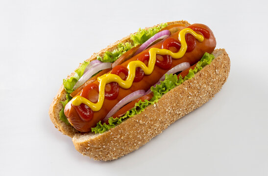 A hot dog topped with mustard and ketchup on a white background.