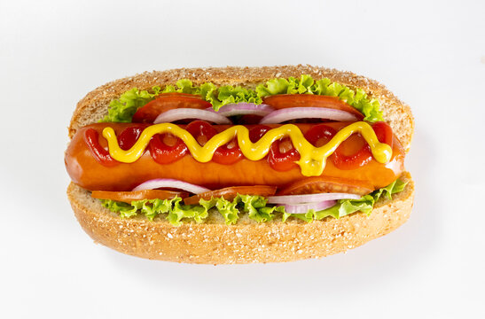 A hot dog topped with mustard and ketchup on a white background.
