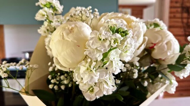Elegant bouquet of fresh white peonies and gypsophila flowers for a wedding celebration