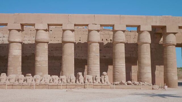 Footage showcasing the majestic Karnak Temple Complex in Luxor, Egypt, featuring the iconic Avenue of Ram headed Sphinxes leading to the towering columns of the Great Hypostyle Hall.