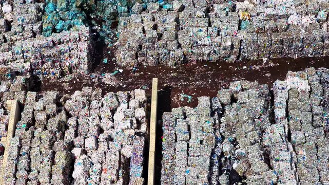 Huge landfill with sorted and compressed paper for recycling in aerial view