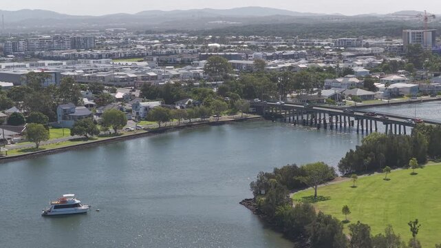 Pleasure Boat In Coombabah Creek Near Jabiru Island Park In Gold Coast, QLD, Australia. - aerial shot