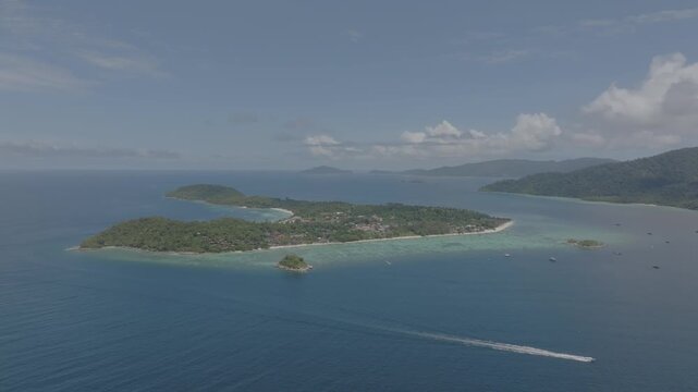 Aerial drone view of Koh Lipe island, Satun, Thailand. Turquoise sea, coral reefs, white sand beaches and traditional long-tail boats in the Andaman Sea.