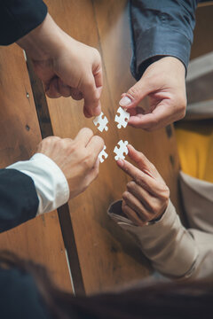 Vertical Stakeholders business trust teams hands holding jigsaw puzzle synergy. Vertical Horizon Implement puzzle improve solve synergy organize team building connection plan trust service strategy