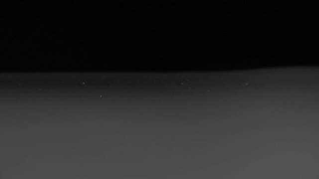 Half-screen white smoke flows in smooth wavy wave patterns across frame.