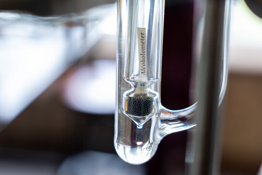 Alcoholometer glass measurement laboratory distillation closeup transparent scientific tool equipment precision liquid scale reading instrument chemistry alcohol beverage brewing gin spirit