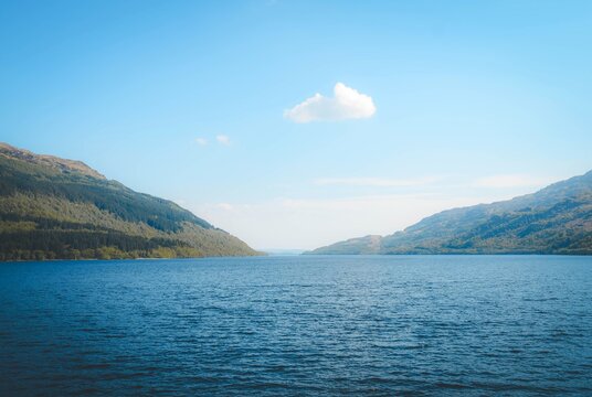 Scenic landscape of a deep blue mountain lake on a bright sunny day in Scottland