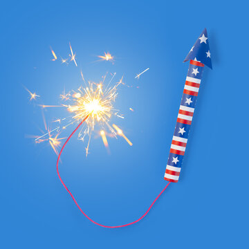 Fourth of July rocket firework with long braided fuse and burning sparks. Lit firework in USA colors of red, white, and blue for patriotic US American 4th of July or America's Independence day.