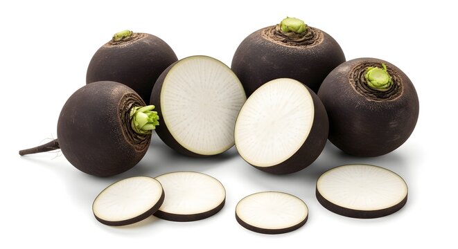 Group of whole and sliced black radishes with white flesh on a clean white surface
