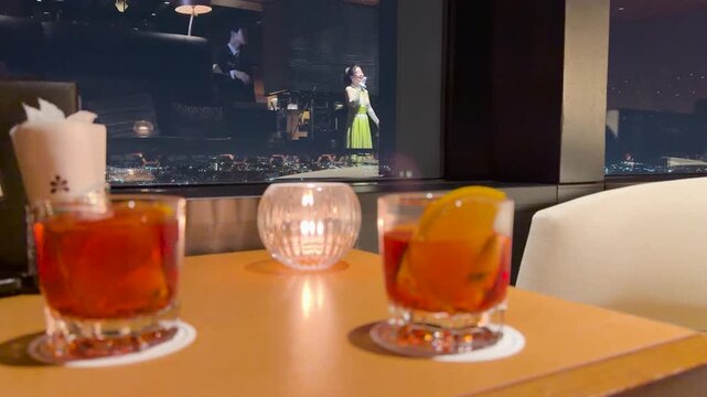 Cocktails on Table in Sky Bar Overlooking Night City View