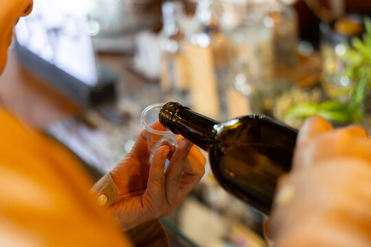 Pouring alcohol bottle hand glass bar beverage drink closeup liquid tasting transparent brown adult party celebration event social hospitality indoors focus selective lifestyle enjoyment