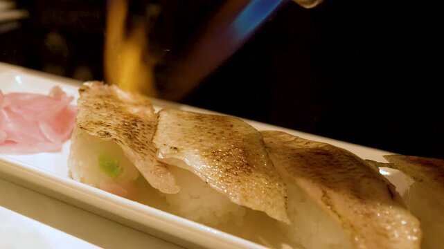 Chef Using Blowtorch to Sear Aburi Sushi in Kanazawa Japan