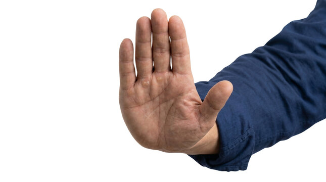 Adult hand raised in a stop gesture against white background