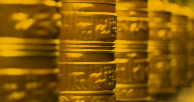 Namche Bazaar, Everest Region, Nepal, static close-up shot of multiple golden Buddhist prayer wheels spinning simultaneously outside a traditional Himalayan gumba.