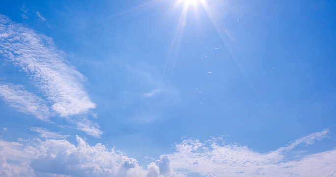 Clear Blue Sky with Soft White Clouds and Bright Natural Daylight Background, Beautiful Clear Blue Sky with Soft White Clouds and Ample Copy Space
Clear blue sky with soft white clouds on a bright sun