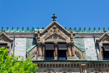 Historic roof dormer with slate shingles and copper cresting on building facade in Charlestown neighborhood of Boston  © Baharlou