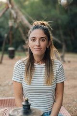 Fototapeta premium Woman with striped shirt relaxing outdoors in nature