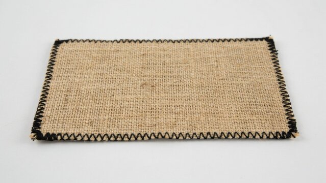 Rectangular burlap fabric patch with black zigzag stitching