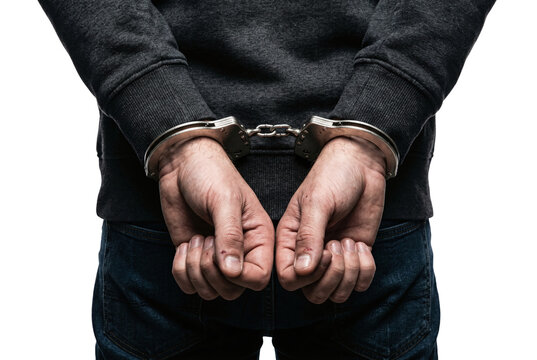 Hands of arrested man in handcuffs behind his back