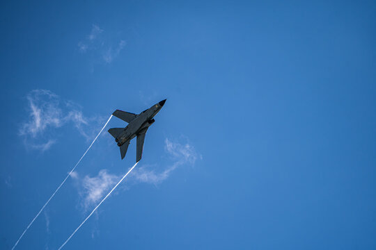 Berlin, Berlin, Germany - 14 June 2026: View of a Panavia Tornado jet performing an aerial display with contrails against a clear blue sky at the ILA Berlin Air Show.