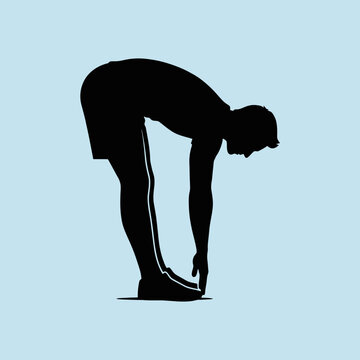 A black silhouette of a man stretching his hamstrings outdoors