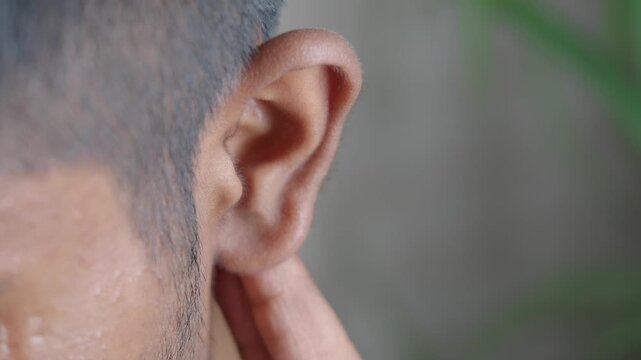 Close-up look at human ear and surrounding skin