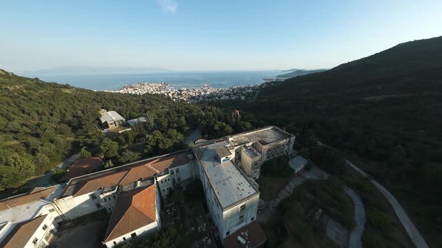 Dynamic Fpv Shot Flyover from Sanatorio Abandoned Hospital to Kavala Greece, Coastal City Background