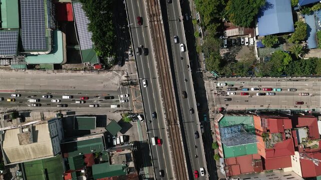 Aerial top-down view of EDSA highway overpass crossing a busy urban junction in Cubao, Quezon City, Metro Manila, Philippines