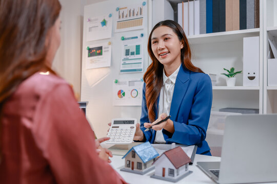 Real estate agent consulting with a client about property investment, home purchase options, mortgage calculations, contract details, and housing market opportunities in a professional office.