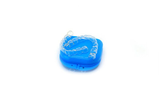 Blue Plastic Retainer Case with Dental Retainers on White Background