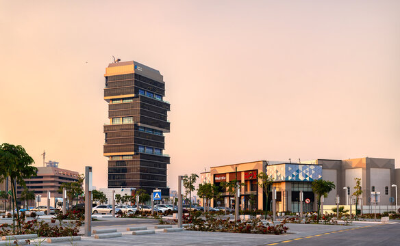 Al Khobar, Saudi Arabia - February 23, 2026: Modern office tower and commercial buildings under a warm sunset sky at the Corniche along Prince Turki Street.