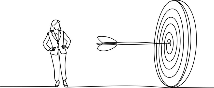 Businesswoman standing with hands on hips near dart in bullseye 