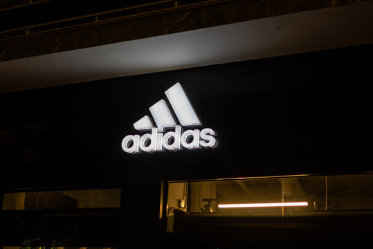 Athens,Greece-September 30, 2024.2024. Photos shows the facade of an Adidas store with an illuminated logo banner at the top of the store.