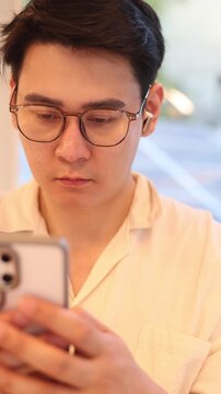 slow motion young man hand hold smartphone to surfing the internet and check work or mail on website while sit in the living room in weekend for business technology and lifestyle concept