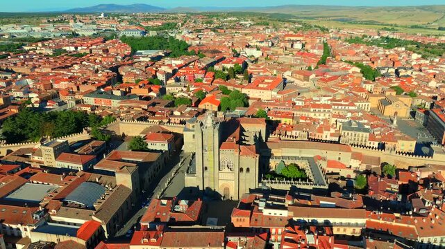 Wide aerial drone shot flying over Avila Spain revealing the cathedral city walls and open Castilian landscape
