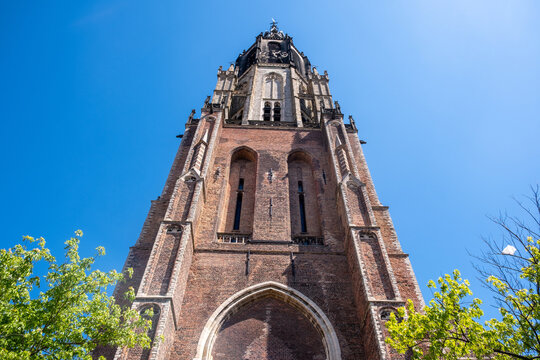 Gothic Brick Tower of Nieuwe Kerk, New Church in Delft Netherlands with clear blue Sky