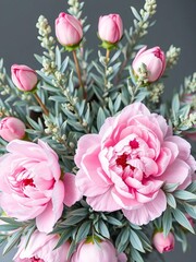 Obraz premium Soft pink peonies bloom amidst delicate blue-green foliage in a watercolor-inspired bouquet, delicate, blue-green